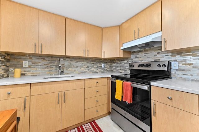 kitchen with stainless steel electric range, a sink, under cabinet range hood, and light countertops