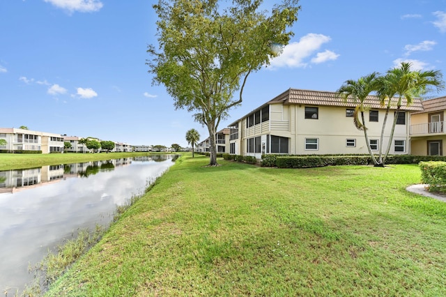 view of property's community featuring a water view and a lawn