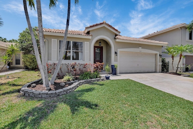 mediterranean / spanish-style house featuring stucco siding, a garage, concrete driveway, a front lawn, and a tile roof