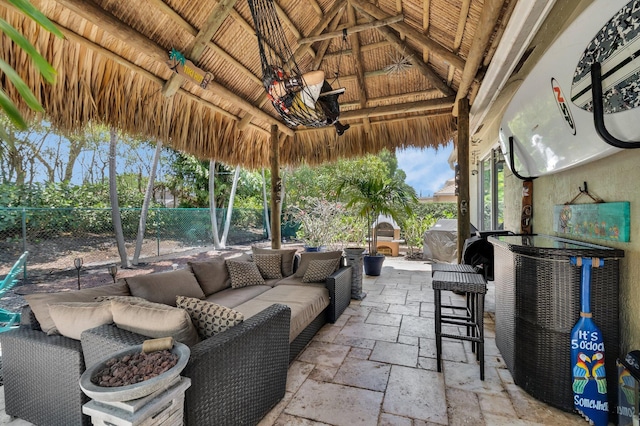 view of patio / terrace featuring a gazebo, fence, and an outdoor hangout area