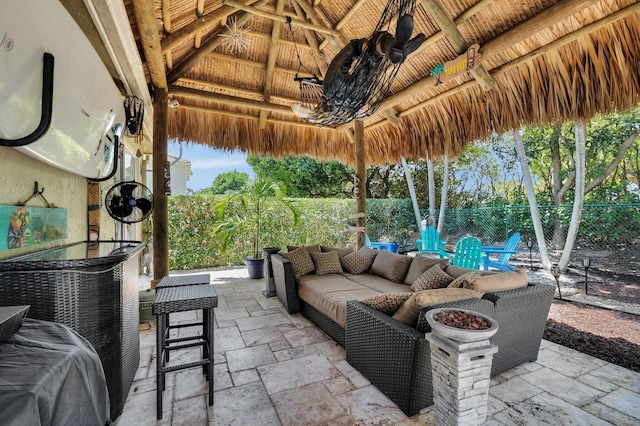 view of patio with a gazebo, fence, and an outdoor hangout area