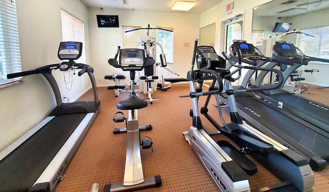 gym featuring healthy amount of natural light and baseboards