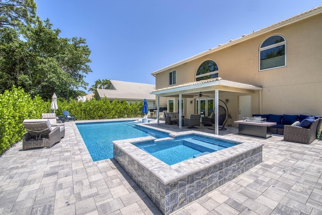 view of pool with an outdoor living space, a ceiling fan, a patio area, and a pool with connected hot tub