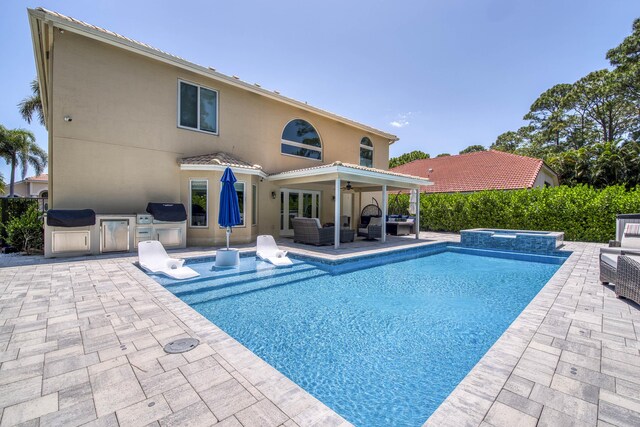 mediterranean / spanish-style home featuring stucco siding, decorative driveway, a garage, and a front lawn