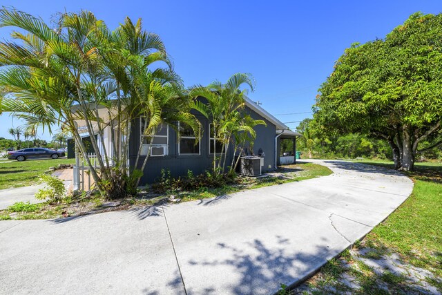 280 NW Airoso Blvd, Port Saint Lucie, FL 34983 - view of property exterior with driveway and stucco siding