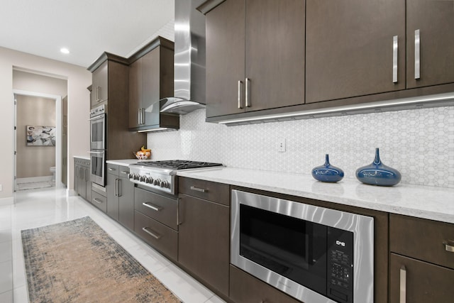 6028 Curie Pl, Palm Beach Gardens, FL 33418 - kitchen with stainless steel appliances, dark brown cabinetry, wall chimney range hood, and recessed lighting