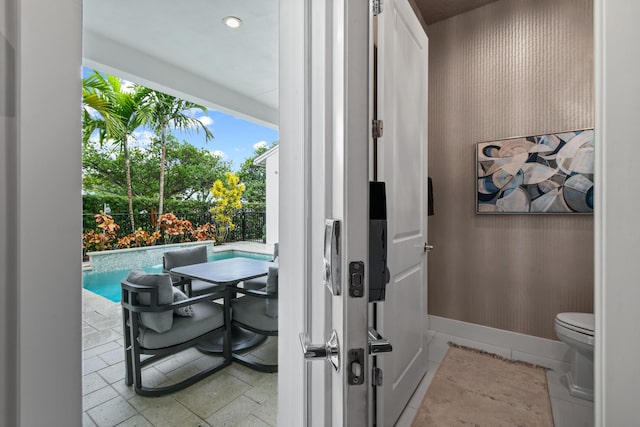 6028 Curie Pl, Palm Beach Gardens, FL 33418 - doorway to outside featuring baseboards