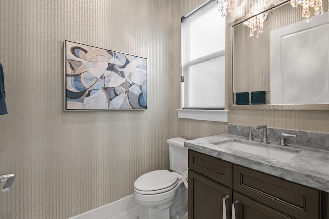 6028 Curie Pl, Palm Beach Gardens, FL 33418 - bathroom featuring wallpapered walls, a chandelier, toilet, and vanity