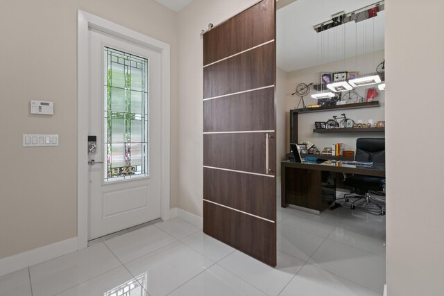 6028 Curie Pl, Palm Beach Gardens, FL 33418 - entryway featuring a desk, baseboards, and light tile patterned floors