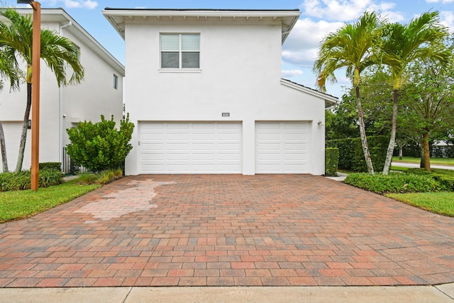 6028 Curie Pl, Palm Beach Gardens, FL 33418 - garage featuring decorative driveway