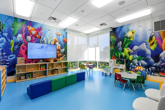 6028 Curie Pl, Palm Beach Gardens, FL 33418 - playroom with a paneled ceiling and finished concrete floors