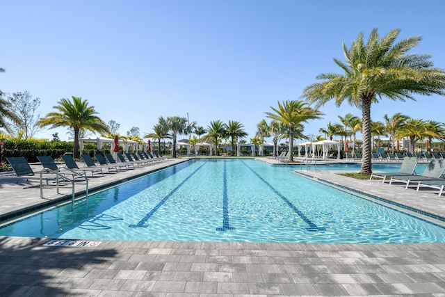 6028 Curie Pl, Palm Beach Gardens, FL 33418 - community pool featuring a patio