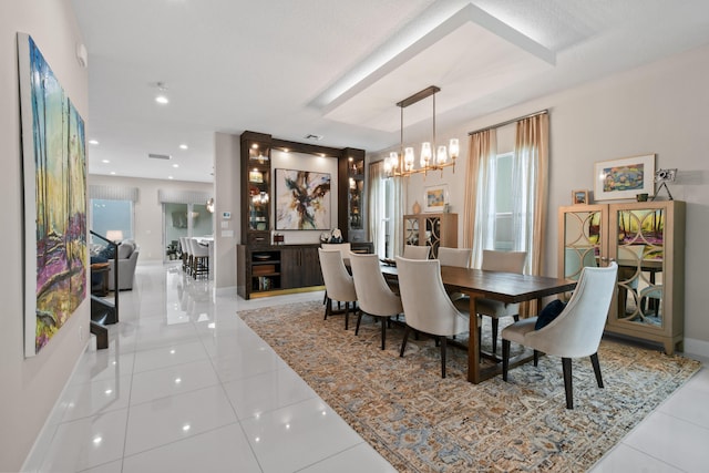 6028 Curie Pl, Palm Beach Gardens, FL 33418 - dining space featuring light tile patterned floors, a chandelier, and baseboards