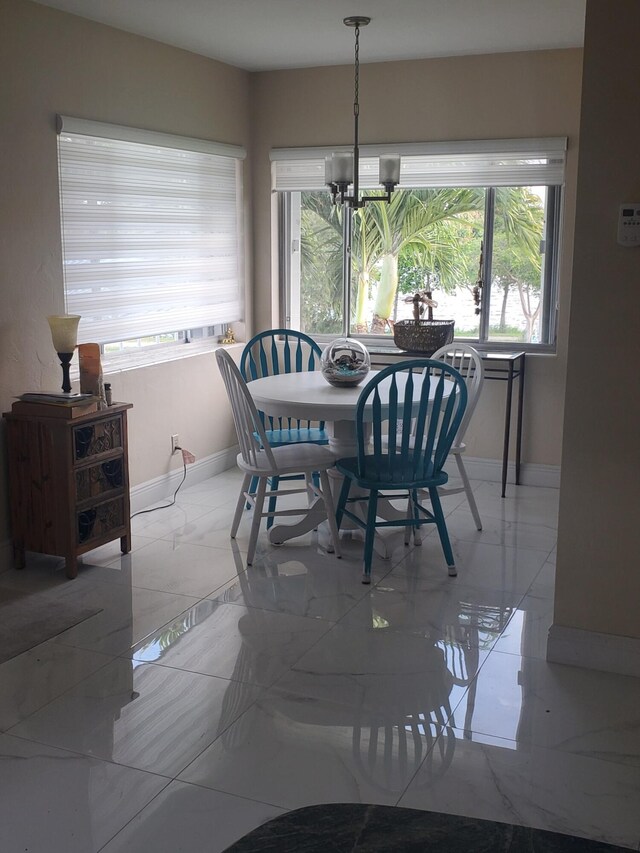 3160 Lake Osborne Dr Unit 201, Lake Worth, FL 33461 - dining space with baseboards, a chandelier, and marble finish flooring