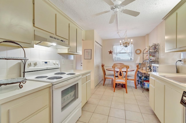 kitchen featuring white electric stove, under cabinet range hood, cream cabinetry, a textured ceiling, and light countertops