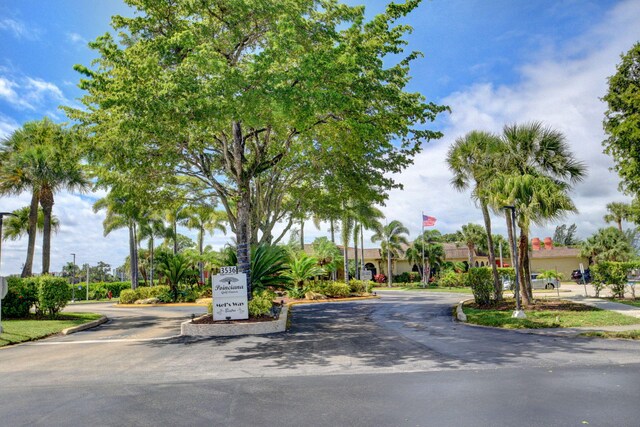 view of asphalt street featuring curbs