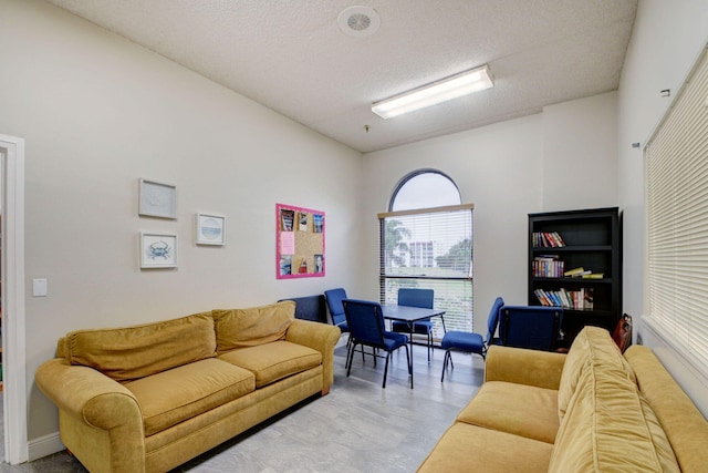 living area featuring a textured ceiling
