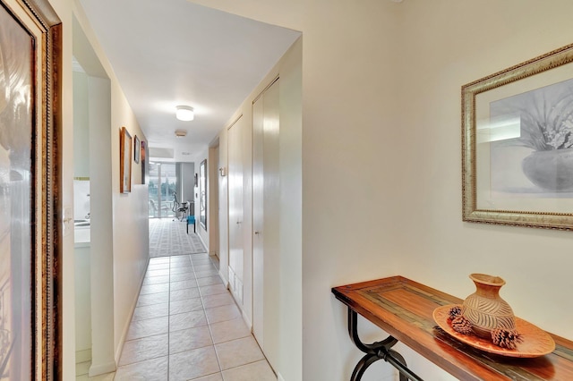 hall with light tile patterned floors and baseboards