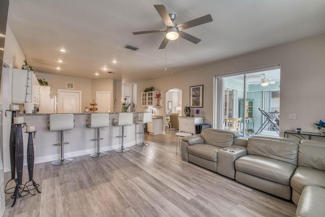 2720 SE Kern Rd, Port Saint Lucie, FL 34984 - living area with a ceiling fan, arched walkways, light wood-type flooring, recessed lighting, and baseboards