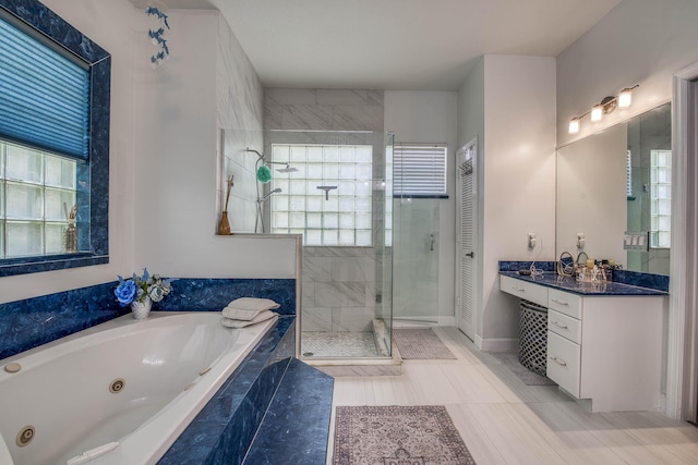 2720 SE Kern Rd, Port Saint Lucie, FL 34984 - full bath with a shower stall, a tub with jets, vanity, tile patterned floors, and baseboards