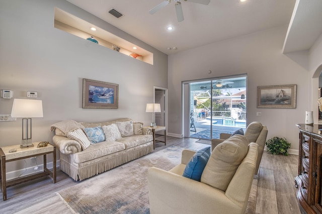 2720 SE Kern Rd, Port Saint Lucie, FL 34984 - living room featuring baseboards, a ceiling fan, wood finished floors, recessed lighting, and a towering ceiling