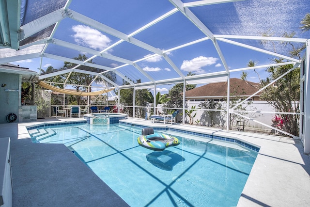 2720 SE Kern Rd, Port Saint Lucie, FL 34984 - view of pool featuring a patio, a pool with connected hot tub, and glass enclosure