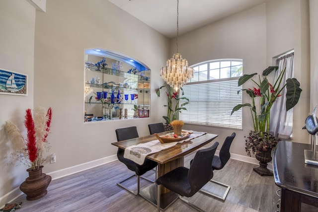 2720 SE Kern Rd, Port Saint Lucie, FL 34984 - dining space featuring wood finished floors, baseboards, and a chandelier