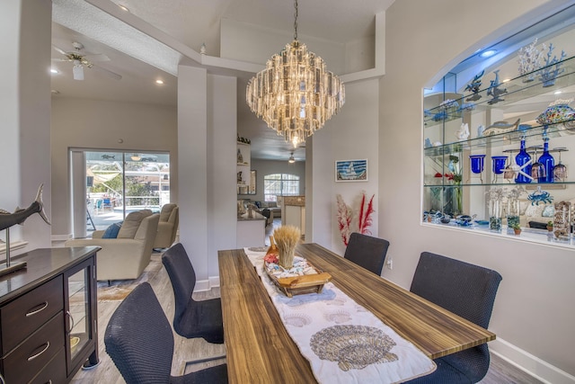 2720 SE Kern Rd, Port Saint Lucie, FL 34984 - dining space featuring plenty of natural light, a chandelier, a ceiling fan, and wood finished floors