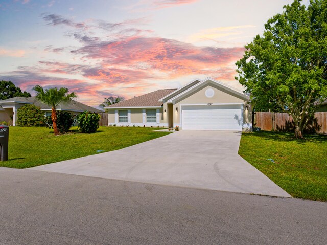 3227 SW Foremost Dr, Port Saint Lucie, FL 34953 - view of front of house featuring driveway, an attached garage, and stucco siding