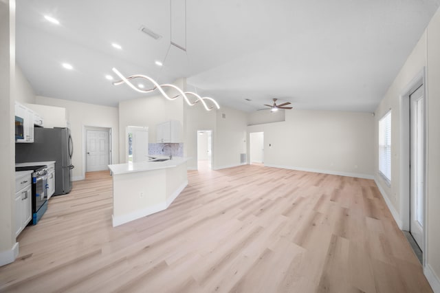 3227 SW Foremost Dr, Port Saint Lucie, FL 34953 - kitchen featuring electric stove, white cabinetry, stainless steel microwave, lofted ceiling, and a ceiling fan