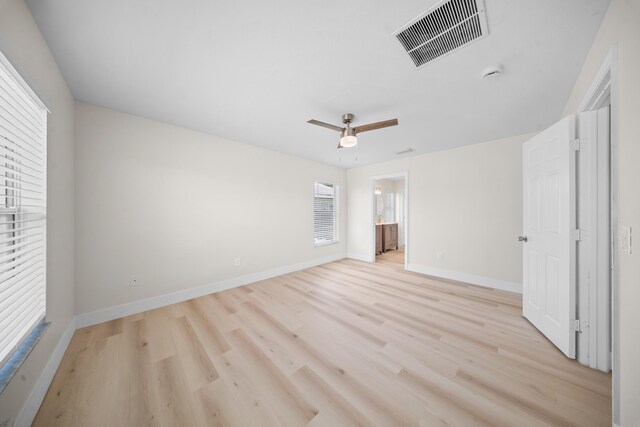 3227 SW Foremost Dr, Port Saint Lucie, FL 34953 - unfurnished bedroom featuring light wood-type flooring, baseboards, ensuite bath, and ceiling fan