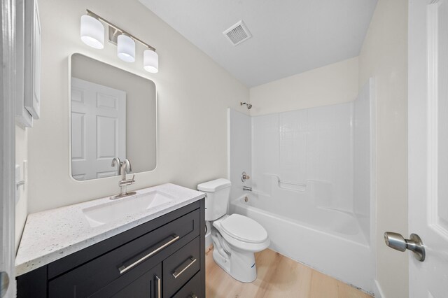 3227 SW Foremost Dr, Port Saint Lucie, FL 34953 - full bathroom with wood finished floors, toilet, vanity, and bathtub / shower combination