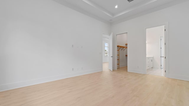 spare room featuring light wood finished floors, baseboards, and recessed lighting