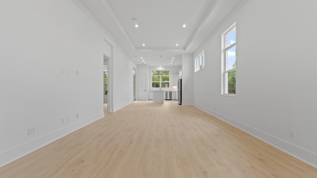 unfurnished living room featuring light wood-style floors, recessed lighting, and baseboards