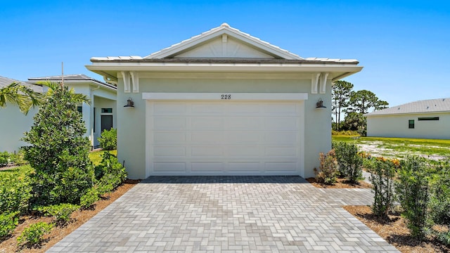 garage with decorative driveway