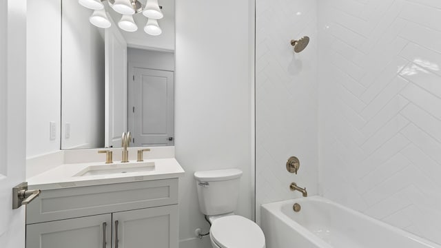 bathroom featuring toilet, vanity, and tub / shower combination