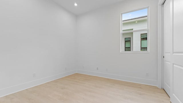 unfurnished room with light wood-style floors, baseboards, and recessed lighting
