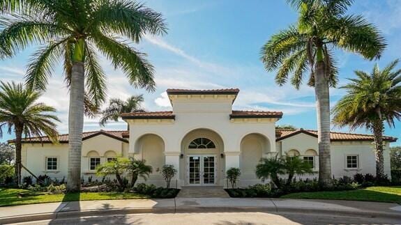 view of front of home featuring french doors, stucco siding, and a tile roof