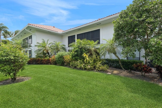 4078 Quail Ridge Dr N Unit A, Boynton Beach, FL 33436 - view of side of home with stucco siding, a tile roof, and a yard