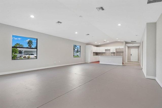 6728 Spanish Lake Blvd, Fort Pierce, FL 34951 - unfurnished living room featuring baseboards, vaulted ceiling, concrete flooring, and recessed lighting