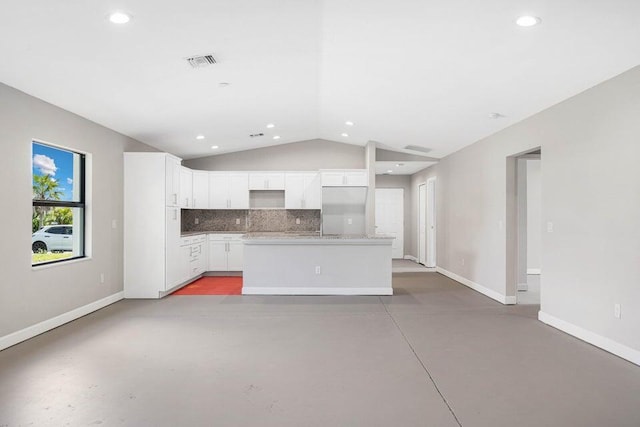 6728 Spanish Lake Blvd, Fort Pierce, FL 34951 - kitchen featuring baseboards, lofted ceiling, finished concrete flooring, recessed lighting, and a center island