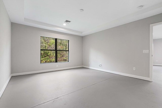 6728 Spanish Lake Blvd, Fort Pierce, FL 34951 - spare room featuring concrete floors, baseboards, recessed lighting, a tray ceiling, and a smoke detector