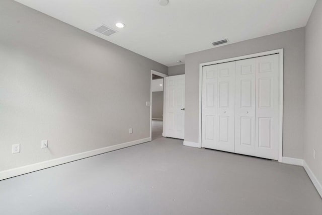 6728 Spanish Lake Blvd, Fort Pierce, FL 34951 - unfurnished bedroom with baseboards, a closet, concrete flooring, and recessed lighting