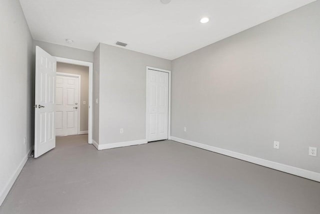 6728 Spanish Lake Blvd, Fort Pierce, FL 34951 - unfurnished bedroom with concrete flooring, baseboards, a closet, and recessed lighting