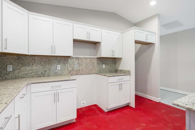 6728 Spanish Lake Blvd, Fort Pierce, FL 34951 - kitchen featuring dark carpet, white cabinets, backsplash, light stone countertops, and baseboards