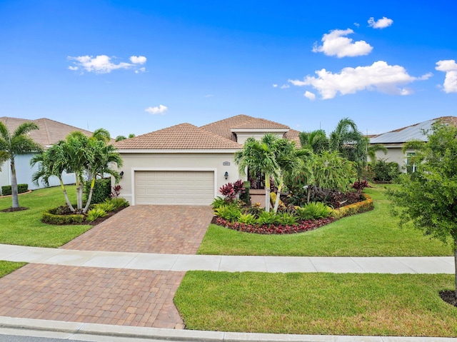 9092 SW Pepoli Way, Port Saint Lucie, FL 34987 - mediterranean / spanish home with an attached garage, a front yard, decorative driveway, and a tiled roof