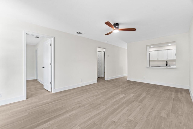 4498 NW 2nd Ave, Boca Raton, FL 33431 - unfurnished living room featuring ceiling fan, light wood-style floors, and baseboards