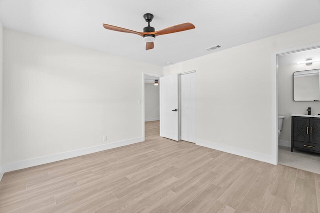4498 NW 2nd Ave, Boca Raton, FL 33431 - unfurnished bedroom featuring light wood-style flooring, baseboards, ensuite bath, and a closet