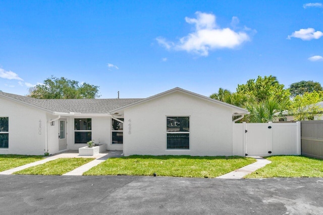 4498 NW 2nd Ave, Boca Raton, FL 33431 - single story home with a gate and stucco siding