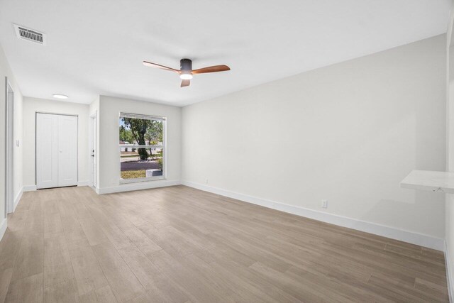 4498 NW 2nd Ave, Boca Raton, FL 33431 - unfurnished living room featuring a ceiling fan, light wood-type flooring, and baseboards